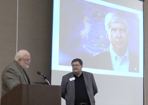 MSU CANR Dean Fred Poston (left) reads from the tribute letter presented to Dr. Chris Peterson, MSU Product Center director, (right) on behalf of Gov. Rick Snyder.