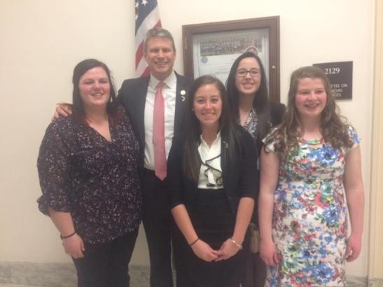 MSU 4-H youth Samantha Beaudrie, Katie Kurburski, Katelyn Stevens and Emma Young pose for a photo with Congressman Huizenga.
