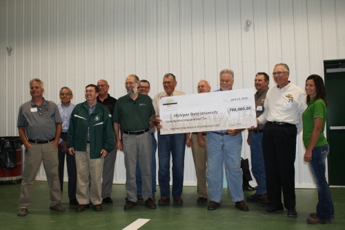 The Michigan Wheat Program board of directors presents a check to Michigan State University during the announcement of their donation.